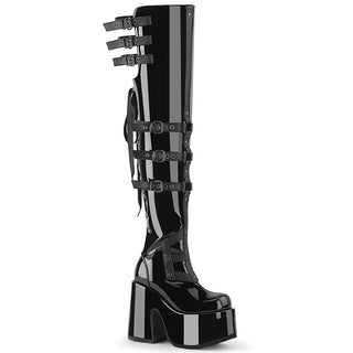 Demonia Camel-308 black patent thigh-high platform boots with back lacing, buckle straps, and chunky heel