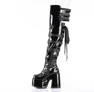 Left side view of Demonia Camel-308 black patent thigh-high platform boot with buckle straps and back ribbon lacing