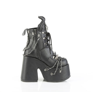 Demonia Camel‑64 black platform ankle boot, inner side view, with chunky heel, devil horns, claw spikes, and barbed wire chain details, on a white background.
