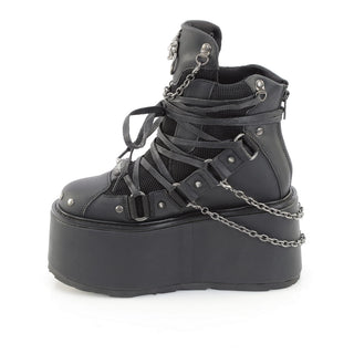 Black cyber goth platform boots side view with chain straps, metal hardware and oversized matte platform sole