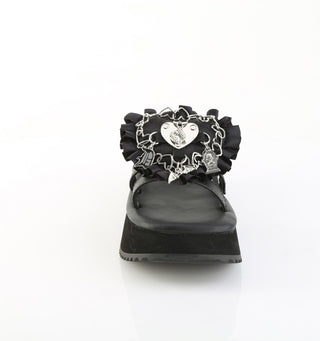 Front view of black Demonia flip-16 platform sandal with silver gothic heart charm, safety pins, and ruffled detailing on the strap.