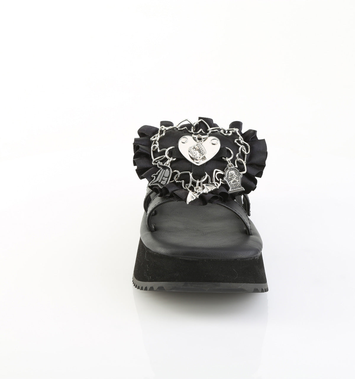 Front view of black Demonia flip-16 platform sandal with silver gothic heart charm, safety pins, and ruffled detailing on the strap.