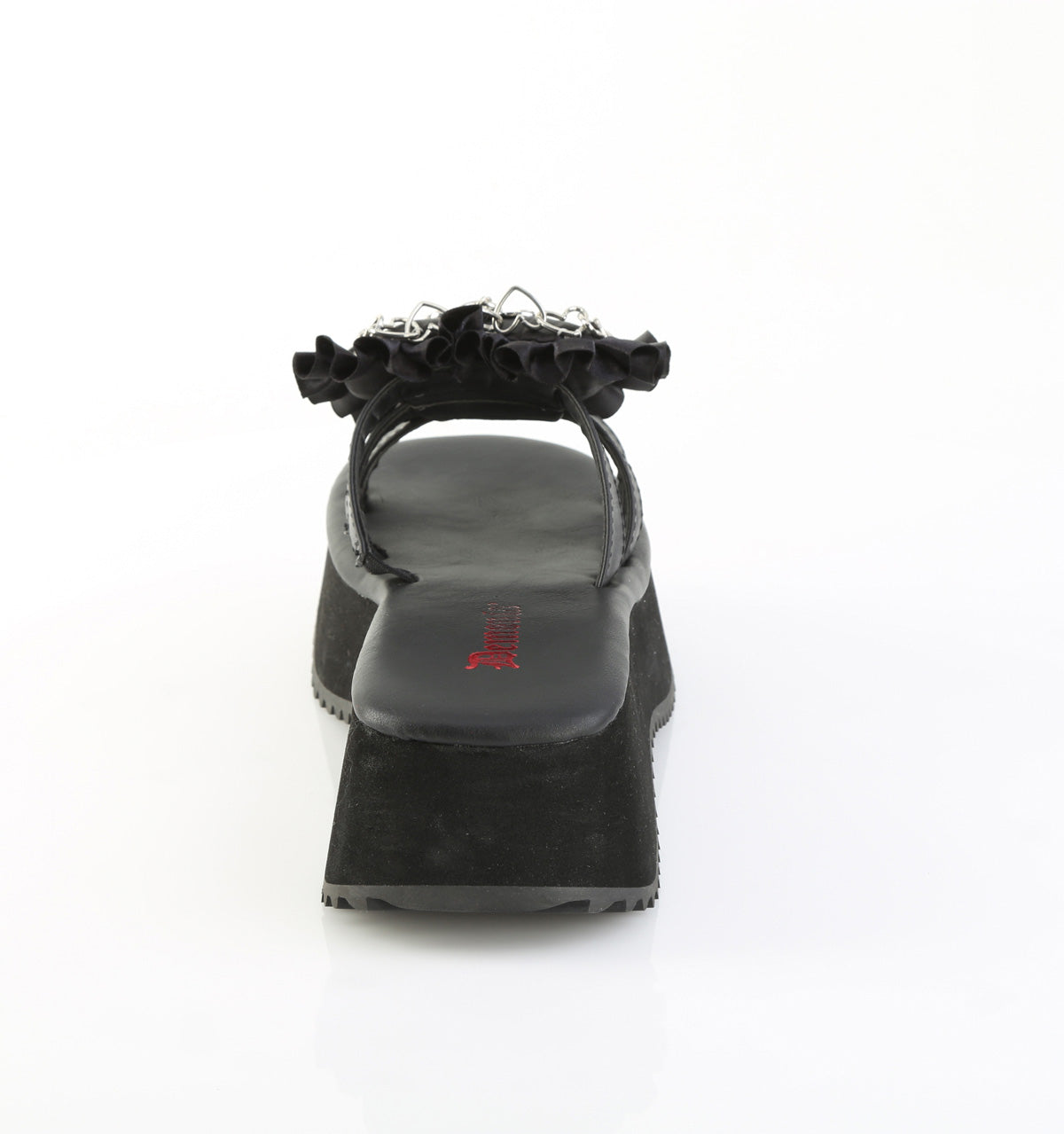 Rear view of black Demonia flip-16 platform sandal showing chunky wedge sole and ruffled strap with gothic charm detail.