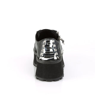 Back view of Demonia Gravedigger-04 black platform Oxford with skull-embossed heel, chrome plates, and spike details on a white background.”