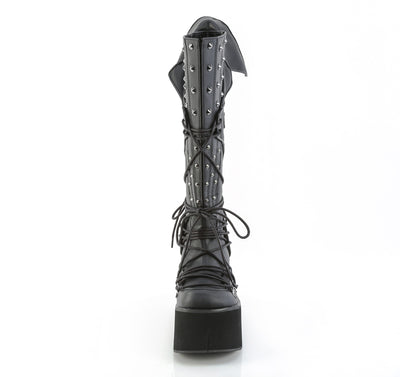 Front view of Demonia KERA-203 black knee-high platform boot with 4.5-inch sole, D-ring lacing, cone spike studs, and vampiric back panel on white background.