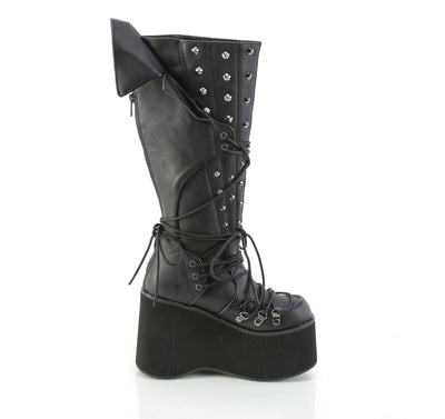 Side view of Demonia KERA-203 black knee-high platform boot with 4.5-inch sole, D-ring lacing, cone spike studs, and vampiric back panel on white background.