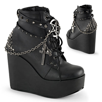 Black wedge ankle boots with studded straps, a pentagram charm, and chain details on a plain white background.