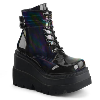 Black holographic Demonia platform boot with wedge sole and double buckle straps, displayed on a white background.