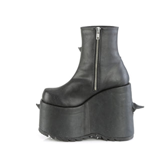 Inner side view of the Demonia Slay-77 black pu boot with side zipper and curved black spikes on a high platform wedge