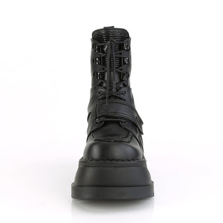 Demonia Stomp-13 black wedge platform ankle boot with lace-up front and hook-and-loop strap, front view on white background.