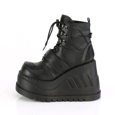 Demonia Stomp-13 black wedge platform ankle boot with lace-up front, hook-and-loop strap, and quilted panels, side view on white background.
