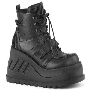 Demonia Stomp-13 black wedge platform ankle boot with lace-up front, hook-and-loop strap, and quilted panels, side view on white background.