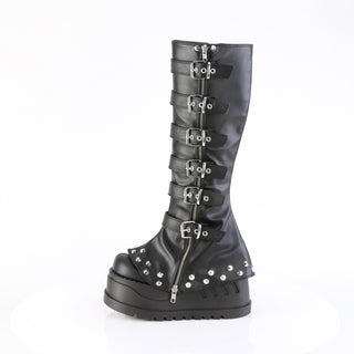 Side view of Demonia Stomp-223 black platform boots showing buckle straps, front zipper, and studded trim