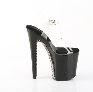 Inner side view of tall black heels with dark pewter spike detailing and clear ankle strap