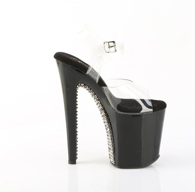 Inner side view of tall black heels with dark pewter spike detailing and clear ankle strap