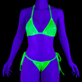 Pleaser Candy-01RS neon green rhinestone bikini set glowing under UV blacklight, with a triangle top and tie-side bottoms.