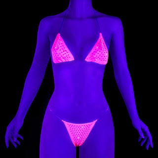 Pleaser Candy-02RS neon pink rhinestone bikini set with clear straps, glowing under UV blacklight.