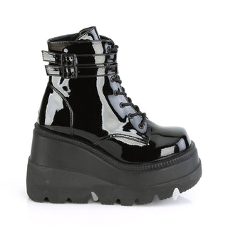 Outer side of Demonia Shaker-52 Black Patent boots with buckle straps and wedge platform