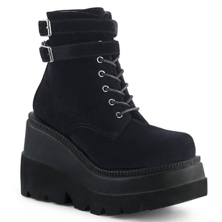Demonia Shaker-52 black velvet boots with a wedge platform and double buckled ankle straps, featuring a lace-up front.