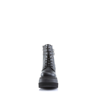 Demonia Shaker-52 Black PU boots – front view showcasing matte black PU, crisscross lace-up closure, and thick platform sole.