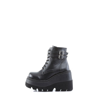 Demonia Shaker-52 Black PU boots – outer side with dual ankle buckle straps, gothic-punk styling, and platform silhouette.