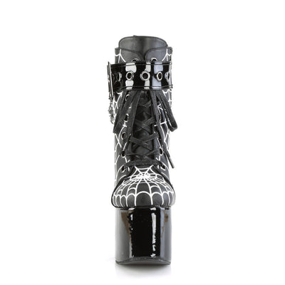 Front view of Demonia Torment-51 platform boots showing black laces, coffin buckle strap, and white spiderweb print on matte upper.