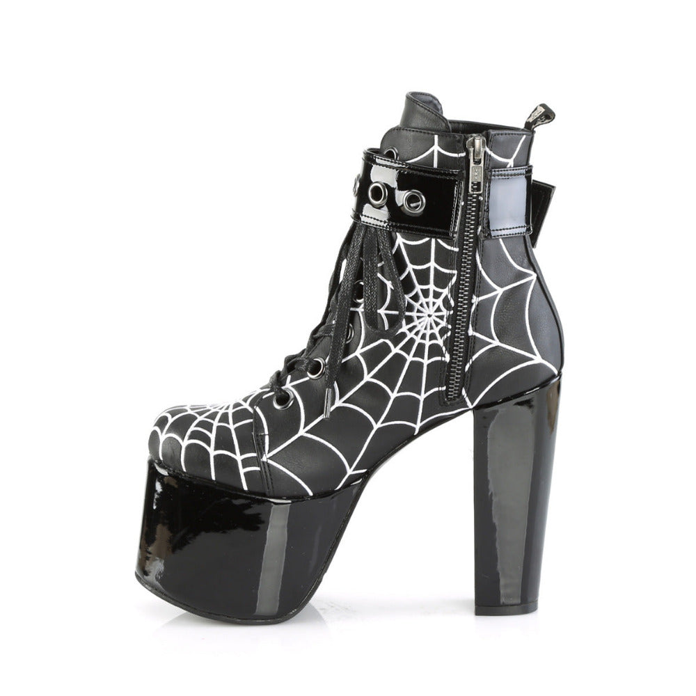 Inner side view of Demonia Torment-51 boots showing inner zipper, spiderweb print, and glossy black platform heel.