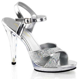 Silver glitter platform sandals with criss-cross toe straps, adjustable ankle strap and clear 4.5-inch stiletto heels.