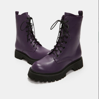 Purple vegan leather combat boots with black soles, lace-up front, and pull tab on the back.