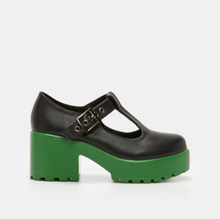 A pair of black Mary Jane platform shoes with chunky green soles and a T-strap buckle design